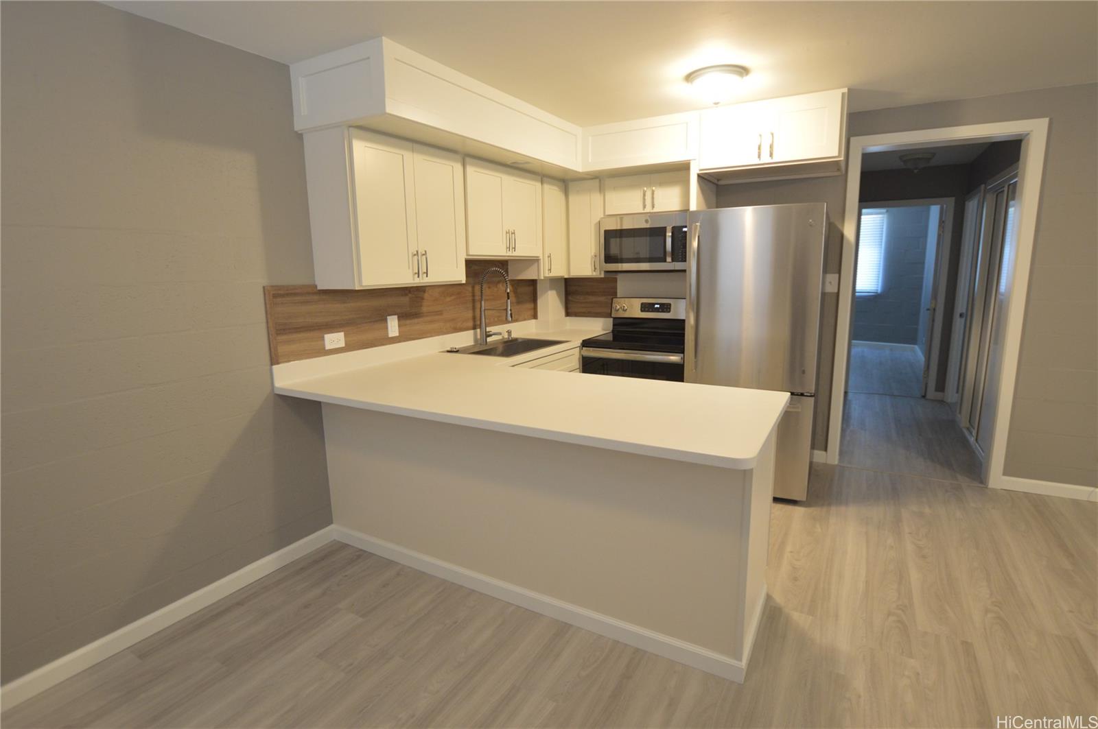 807 Prospect Street, Unit 201 Honolulu, HI 96813 - Photo 1 of 1 a kitchen with a refrigerator a sink and cabinets