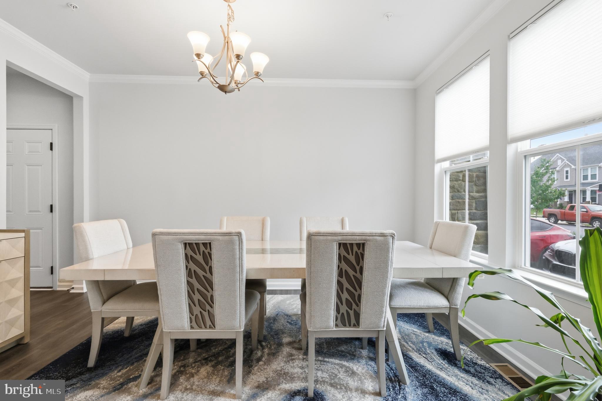 5707 Hawk Ridge Road Frederick, MD 21704 - Photo 22 of 109 a view of a dining room with furniture a chandelier and a window