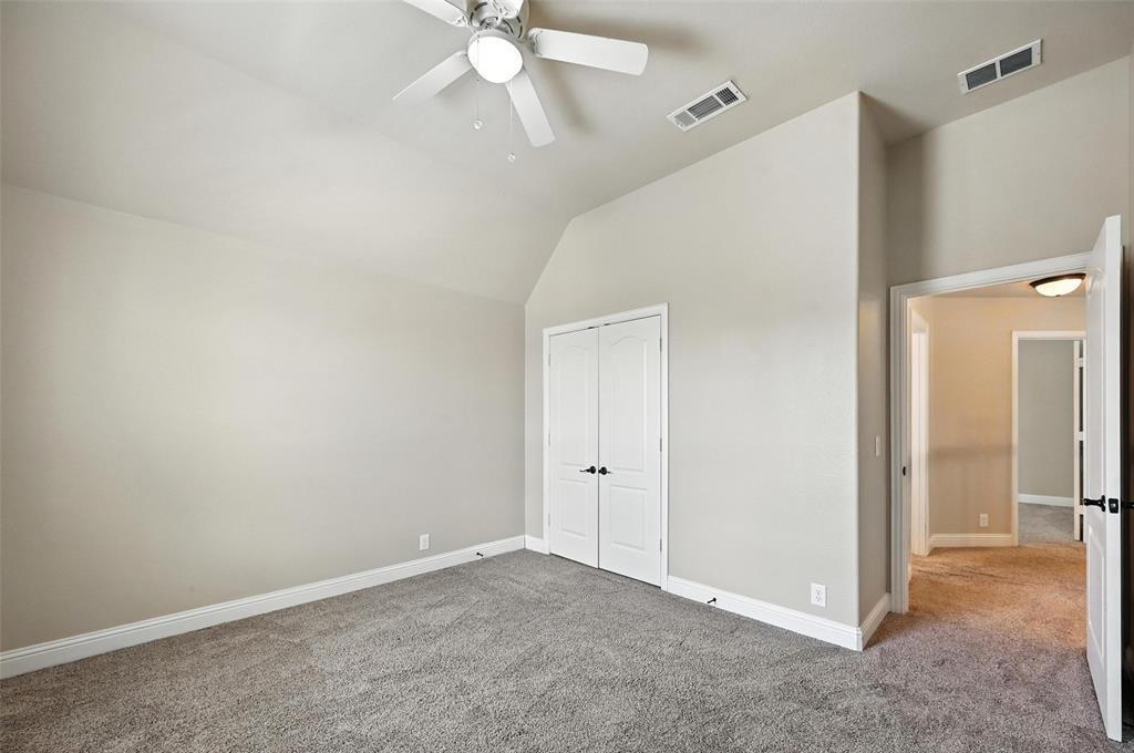 4203 Magnolia Road Melissa, TX 75454 - Photo 14 of 20 Unfurnished bedroom featuring carpet flooring, vaulted ceiling, a closet, and a ceiling fan