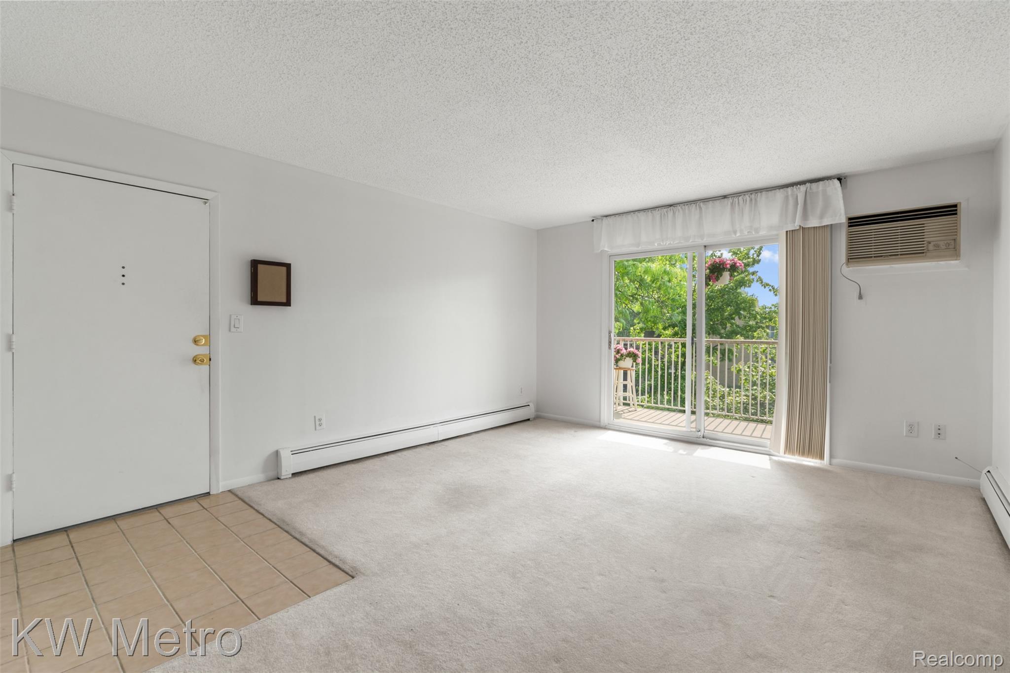 4909 Crooks Road, Unit E8 Royal Oak, MI 48073 - Photo 4 of 13 Entry and Living Room with Doorwall