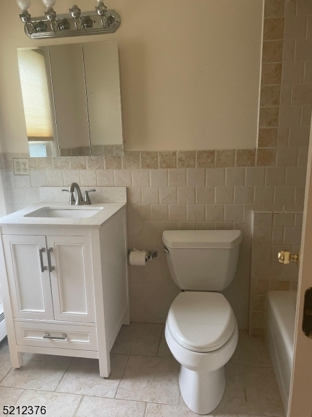 273 Edwards Street Ridgewood, NJ 07450 - Photo 16 of 26 a bathroom with a toilet sink and mirror