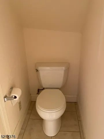 a white toilet sitting next to a bathroom sink