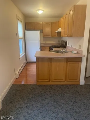 a kitchen with a sink cabinets and appliances