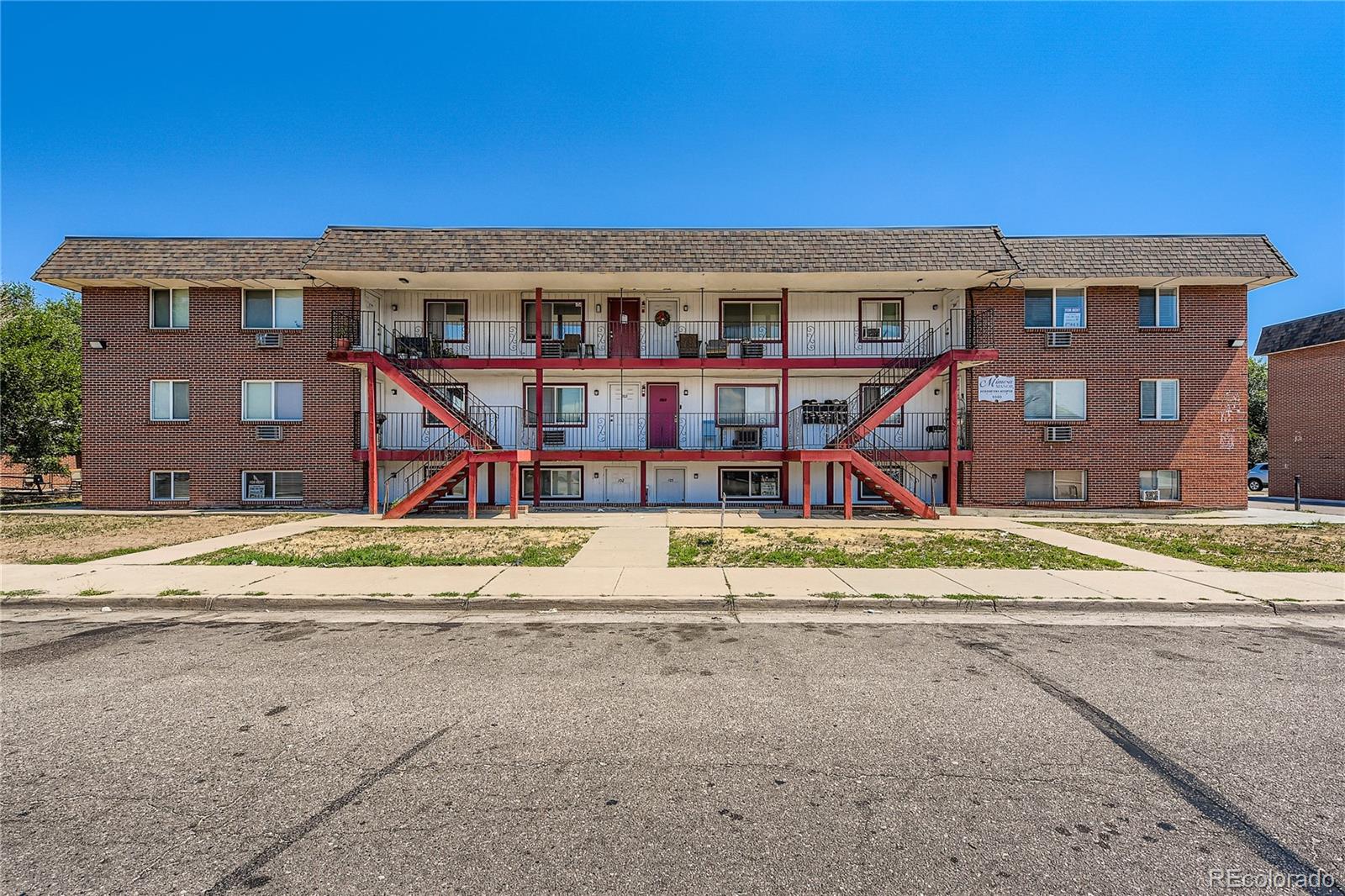 1090 South Eliot Street, Unit 102 Denver, CO 80219 - Photo 1 of 12 a front view of residential houses with street