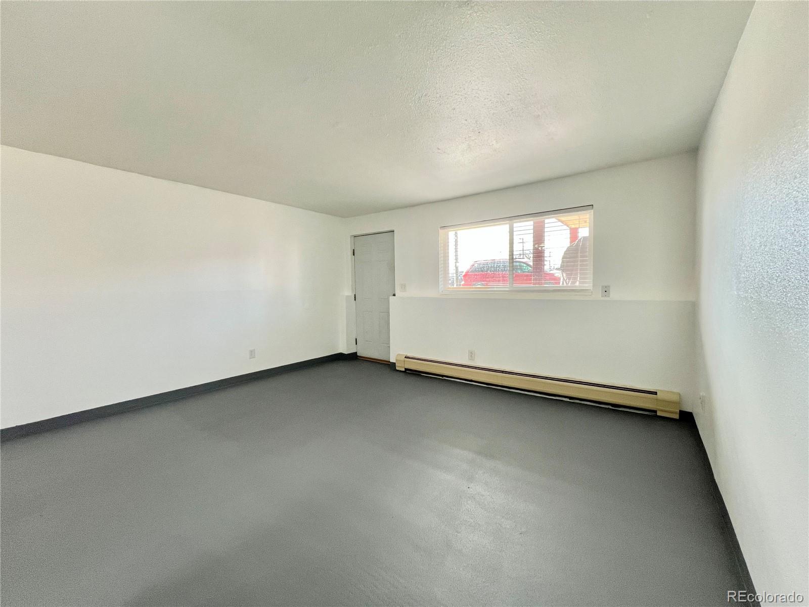 1090 South Eliot Street, Unit 102 Denver, CO 80219 - Photo 7 of 12 an empty room with windows