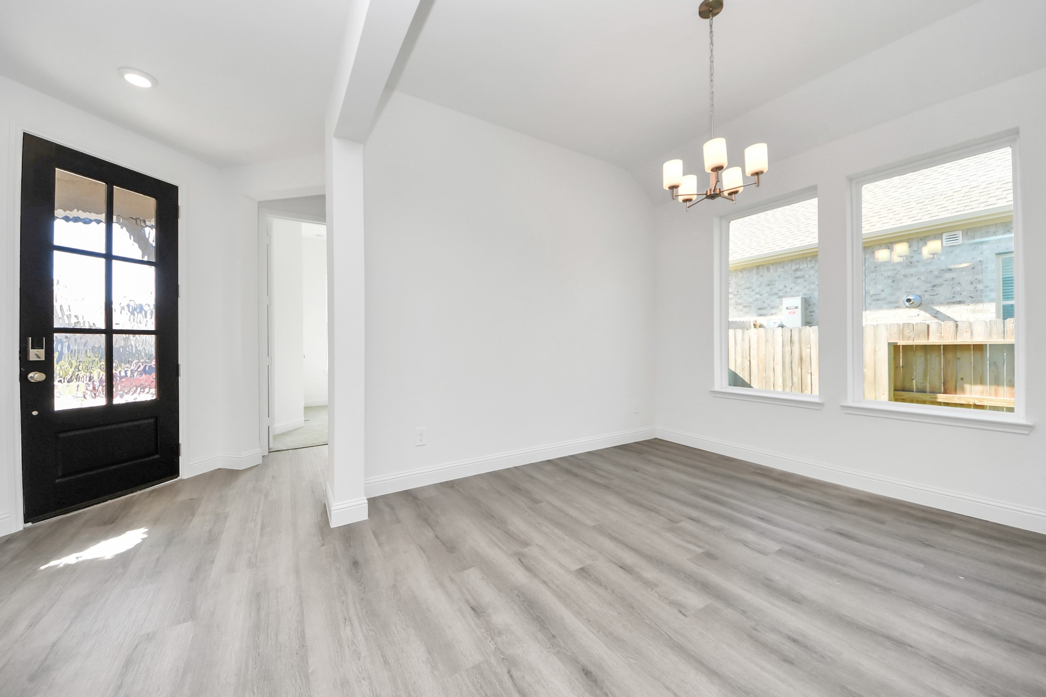 17315 July Moon Lane Conroe, TX 77302 - Photo 20 of 50 an empty room with wooden floor and windows