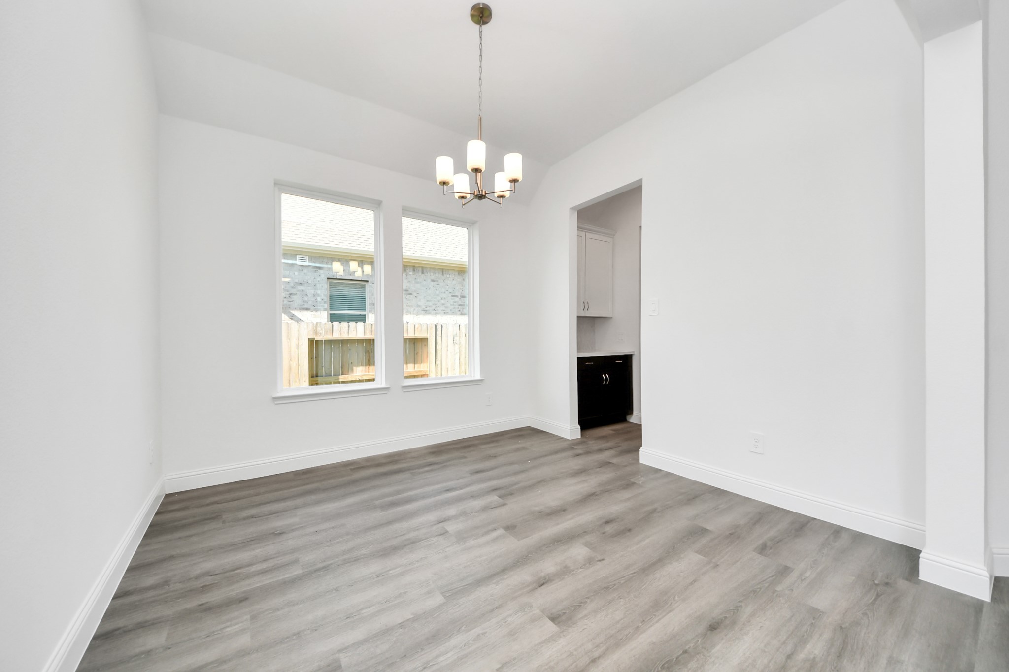 17315 July Moon Lane Conroe, TX 77302 - Photo 21 of 50 a view of an empty room with a window and wooden floor