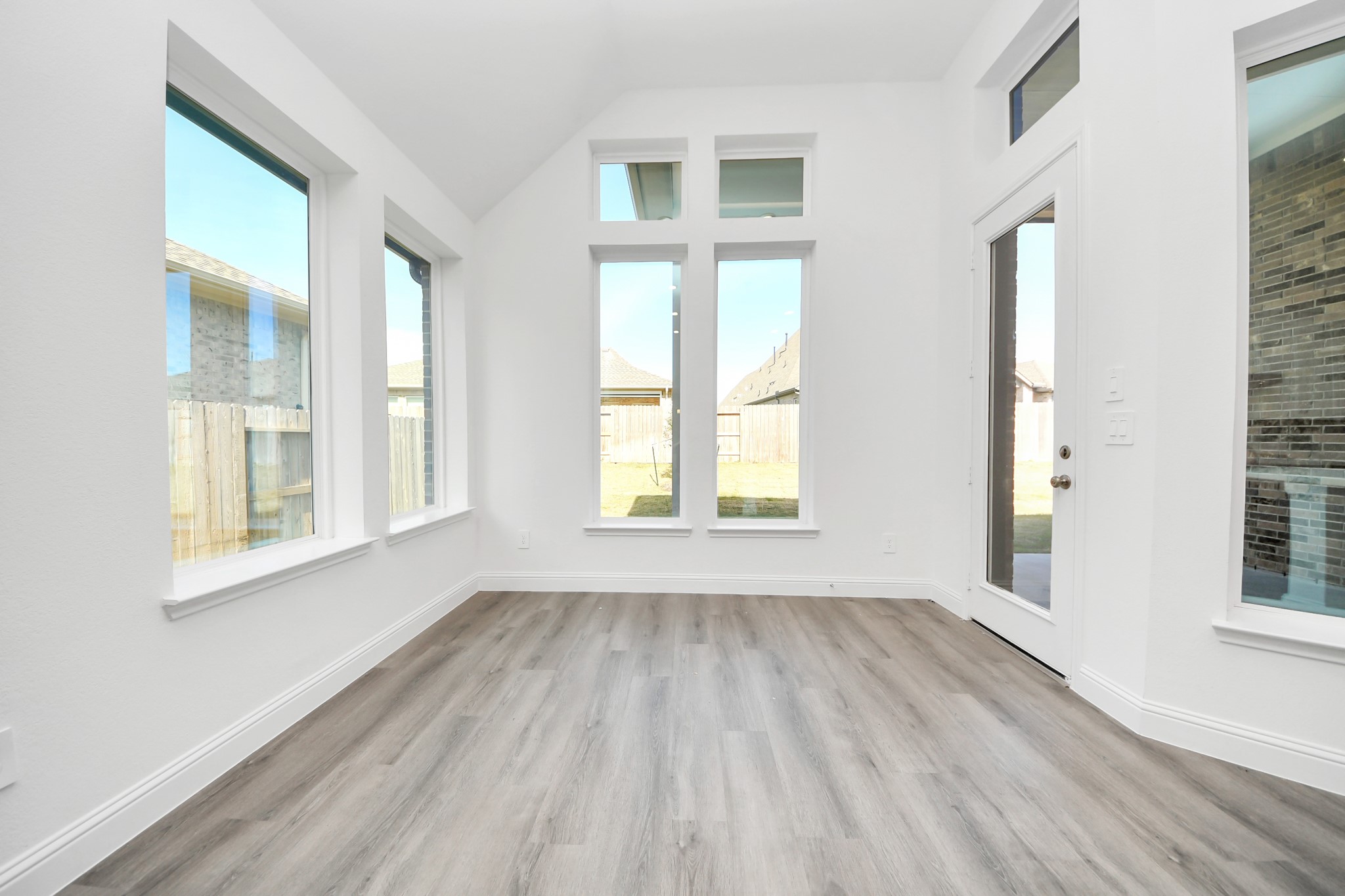 17315 July Moon Lane Conroe, TX 77302 - Photo 31 of 50 a view of an empty room with wooden floor and a window