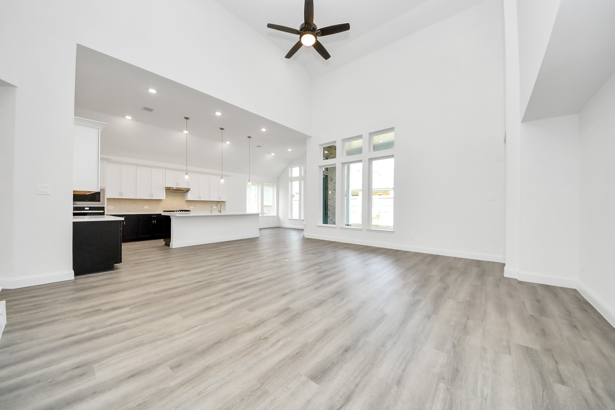 17315 July Moon Lane Conroe, TX 77302 - Photo 35 of 50 a view of kitchen with kitchen island wooden floors and stainless steel appliances