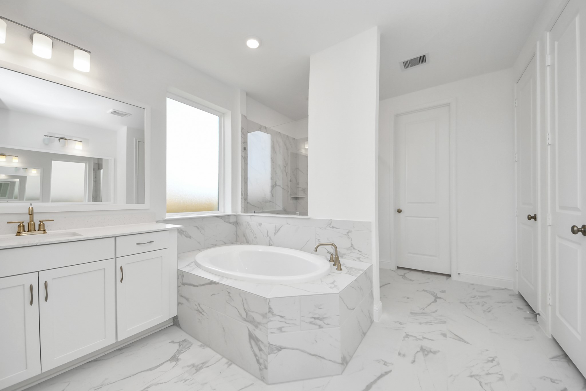 17315 July Moon Lane Conroe, TX 77302 - Photo 43 of 50 a bathroom with a tub sink and mirror