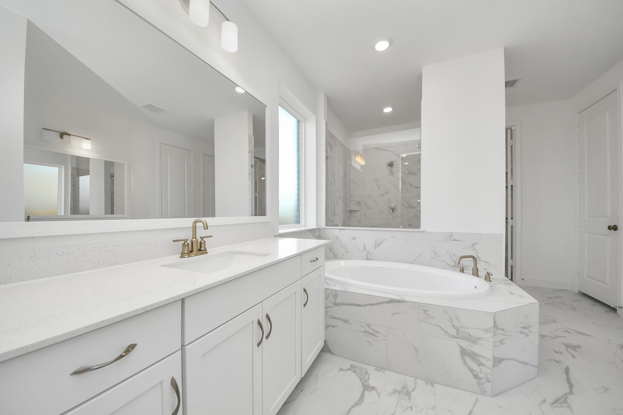 17315 July Moon Lane Conroe, TX 77302 - Photo 47 of 50 a bathroom with a granite countertop sink mirror and bathtub