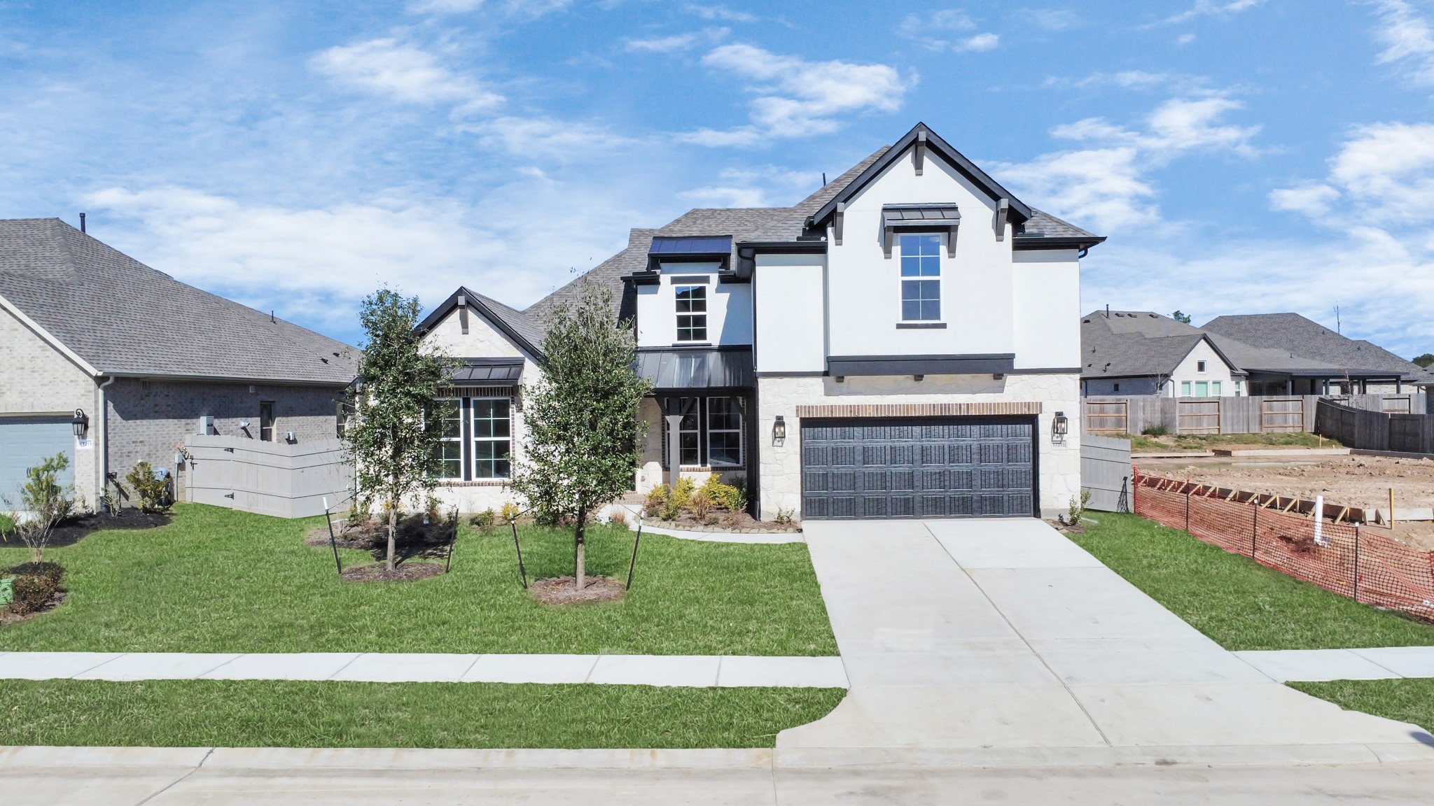 17315 July Moon Lane Conroe, TX 77302 - Photo 5 of 50 a front view of a house with a yard