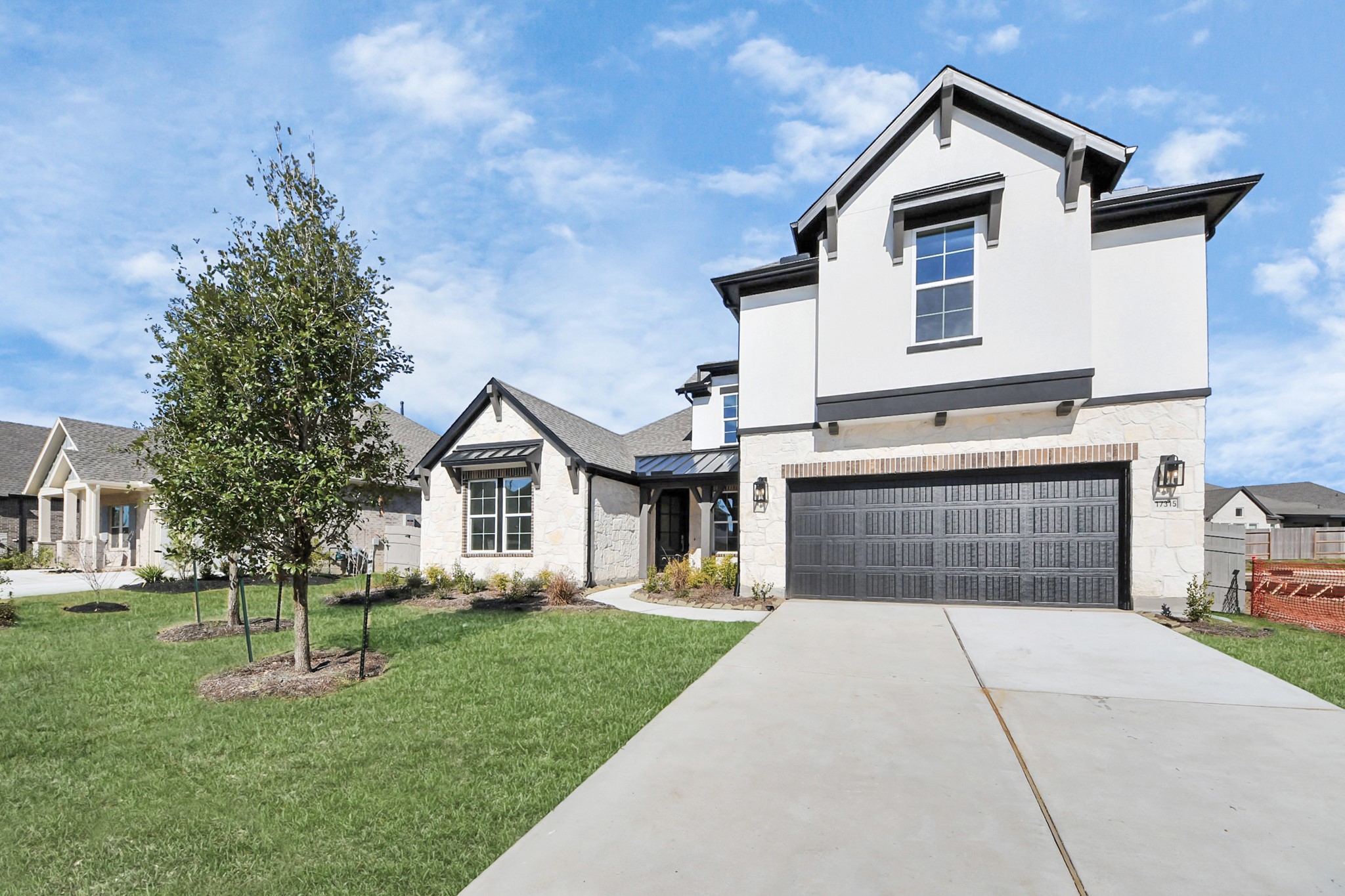 17315 July Moon Lane Conroe, TX 77302 - Photo 7 of 50 a front view of a house with a yard and garage