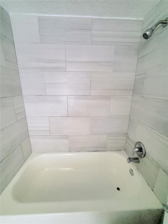 5838 Sun Glo Avenue Port Richey, FL 34668 - Photo 11 of 19 a bathroom with a bathtub