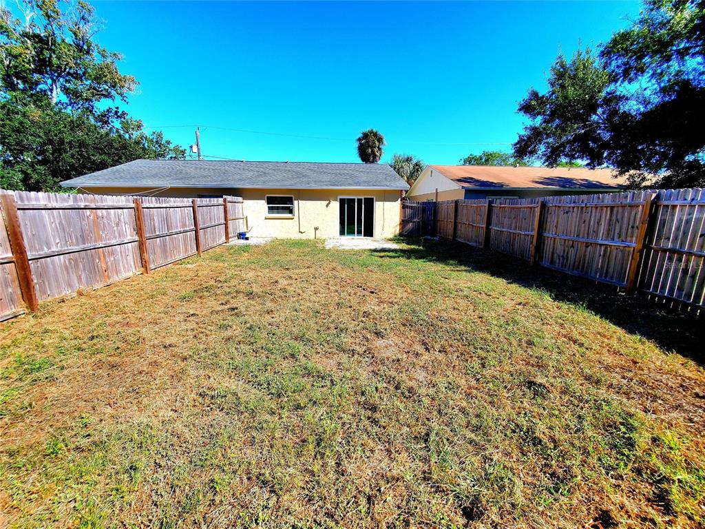 5838 Sun Glo Avenue Port Richey, FL 34668 - Photo 15 of 19 a front view of a house with a garden