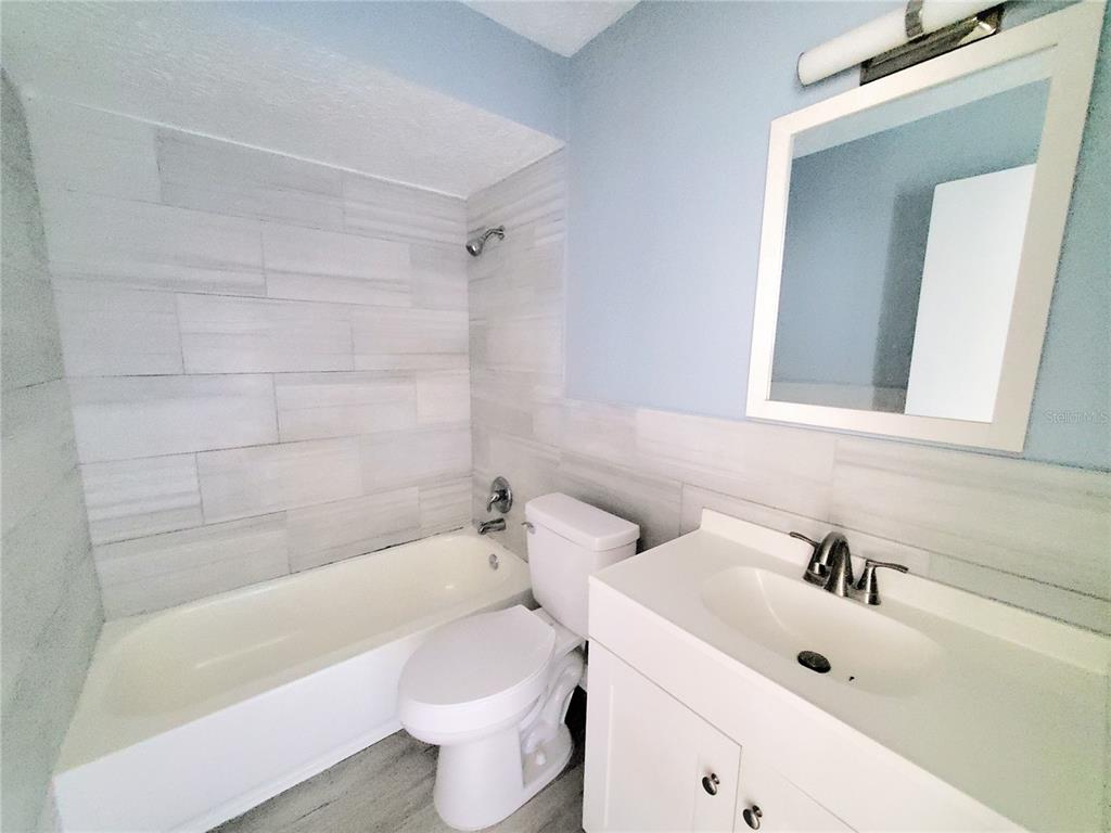 5838 Sun Glo Avenue Port Richey, FL 34668 - Photo 10 of 19 a bathroom with a sink a toilet and bathtub
