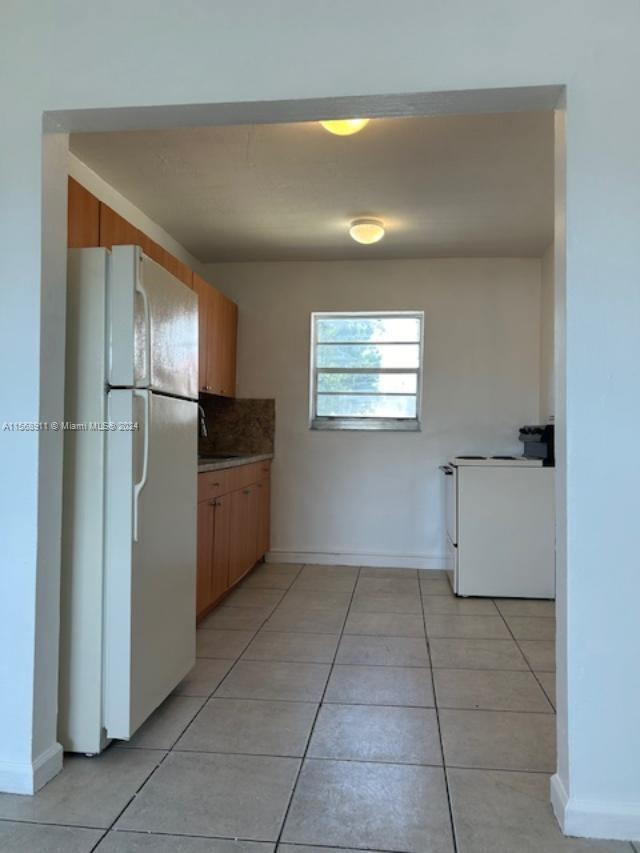 Grapeland Heights Miami, FL 33125 - Photo 7 of 7 a kitchen with a refrigerator and microwave