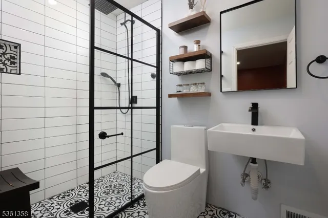 a bathroom with a toilet sink and shower