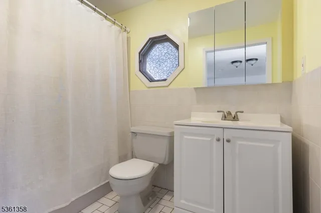 a bathroom with a toilet and a sink