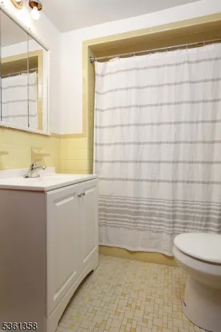 a bathroom with a sink a toilet and mirror
