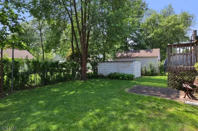 a view of backyard with a garden and deck