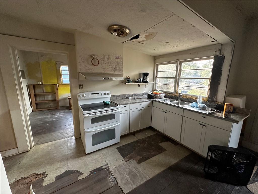 10 Elm Street Covington, GA 30014 - Photo 6 of 14 a kitchen with a sink stove and cabinets