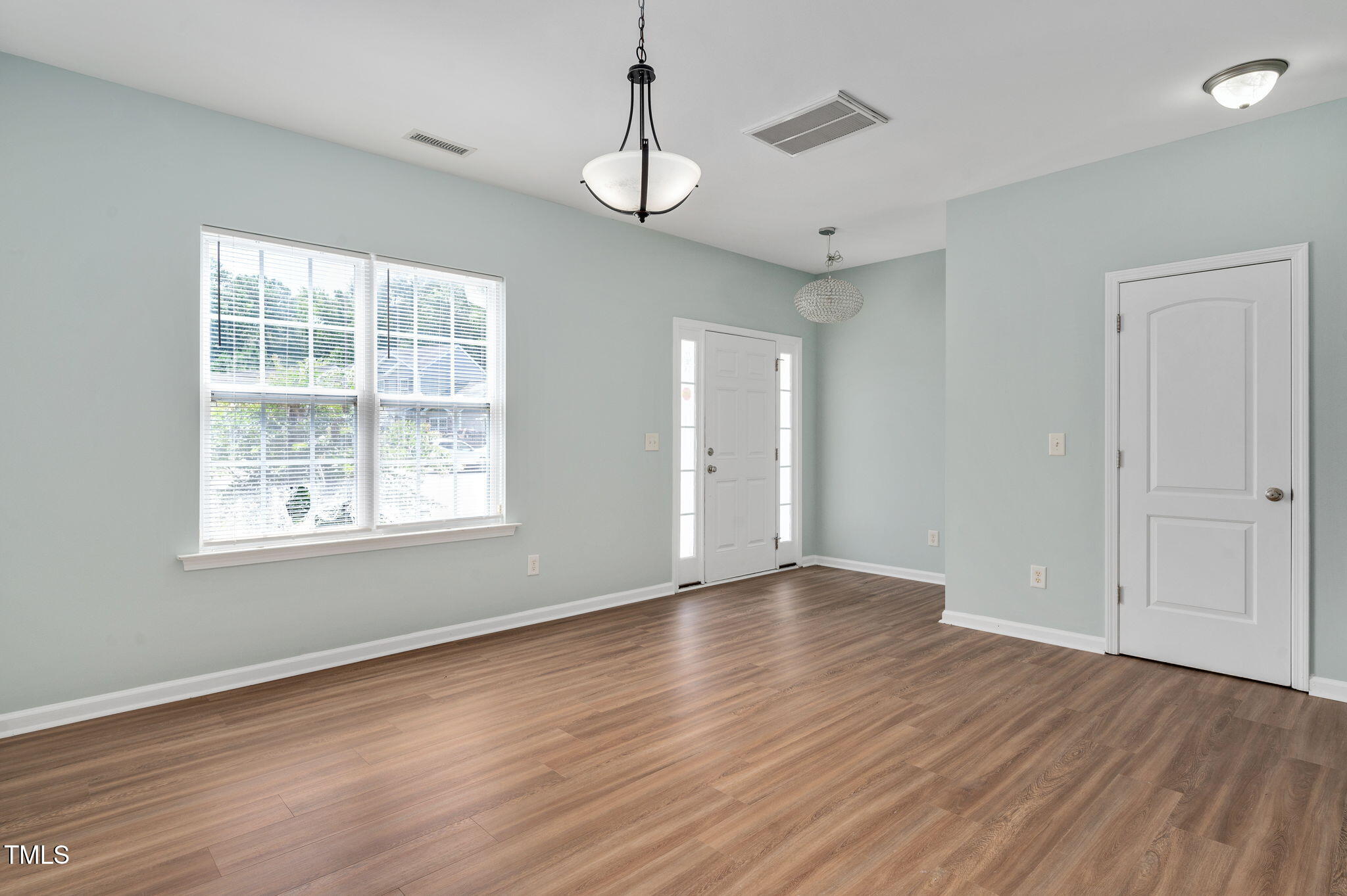 3805 Mike Levi Court Raleigh, NC 27610 - Photo 13 of 34 an empty room with wooden floor and windows