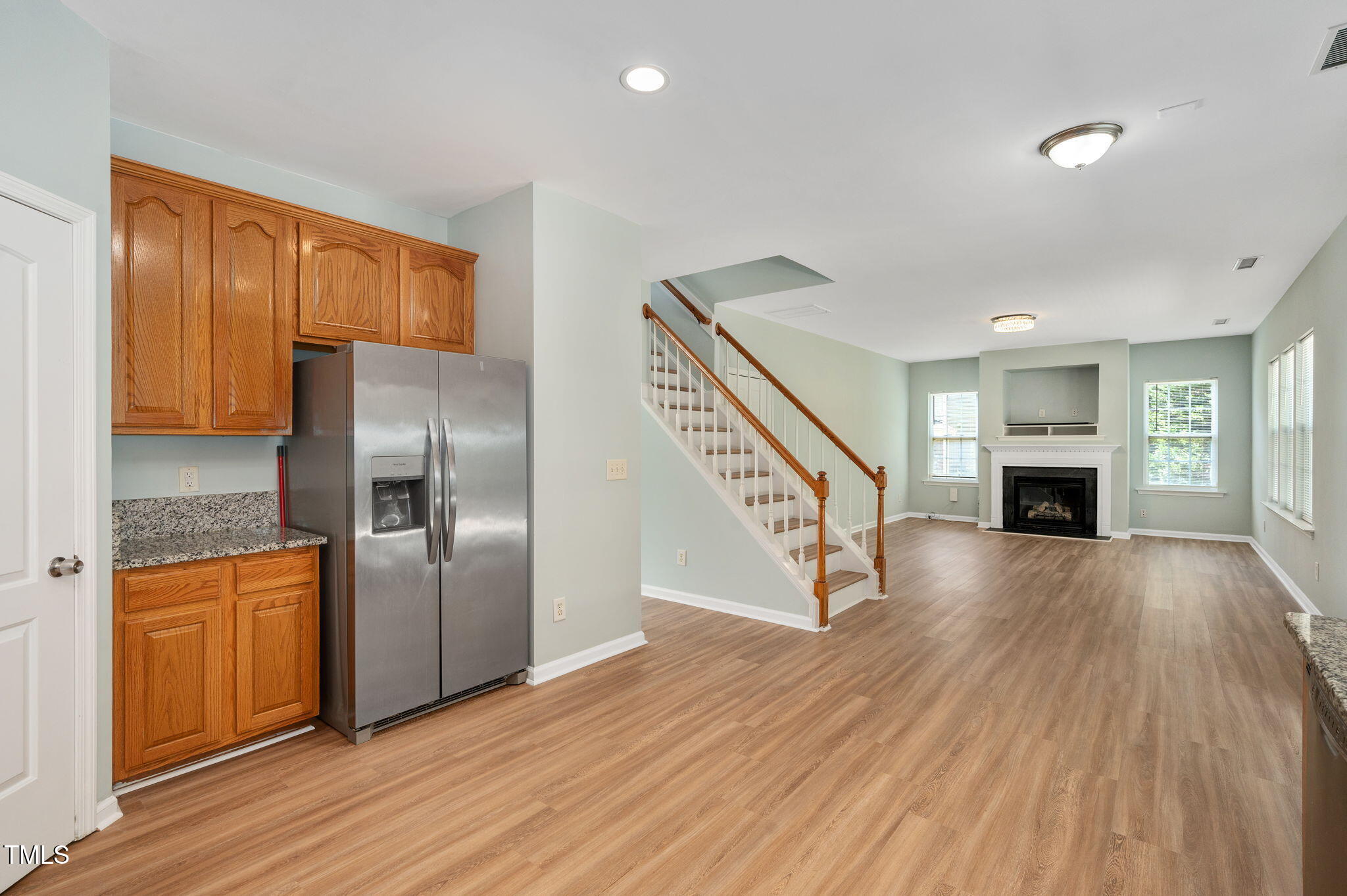 3805 Mike Levi Court Raleigh, NC 27610 - Photo 16 of 34 a view of a livingroom with wooden floor and staircase
