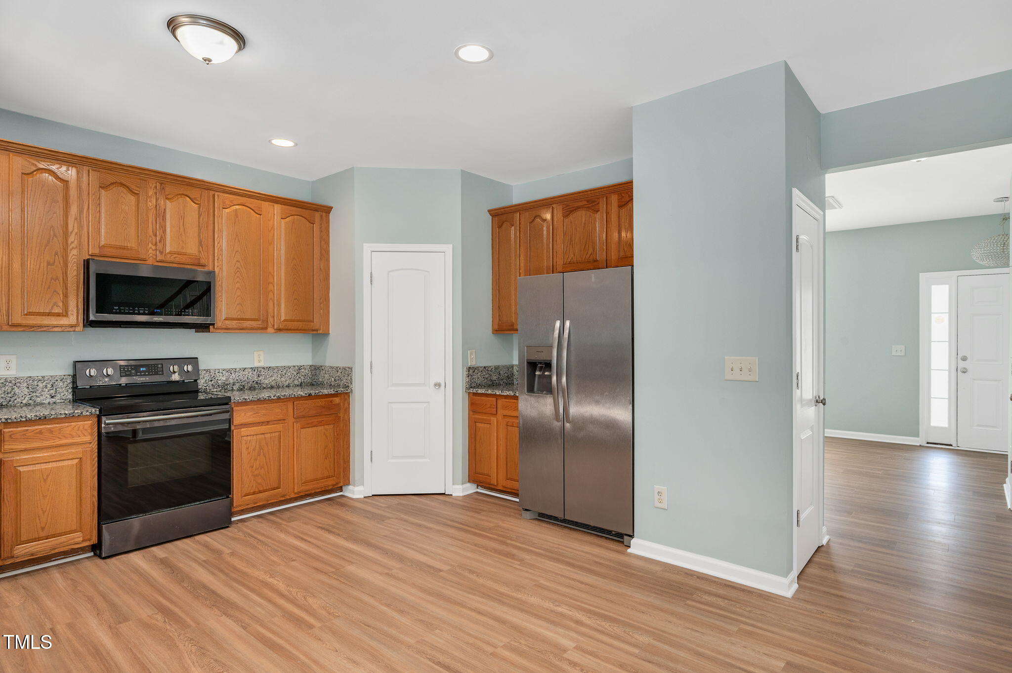 3805 Mike Levi Court Raleigh, NC 27610 - Photo 17 of 34 a kitchen with stainless steel appliances granite countertop a refrigerator microwave and sink