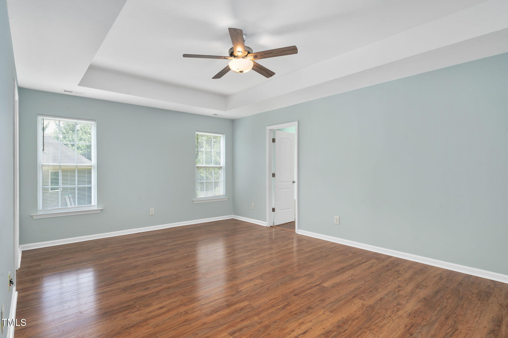 3805 Mike Levi Court Raleigh, NC 27610 - Photo 22 of 34 an empty room with wooden floor fan and windows