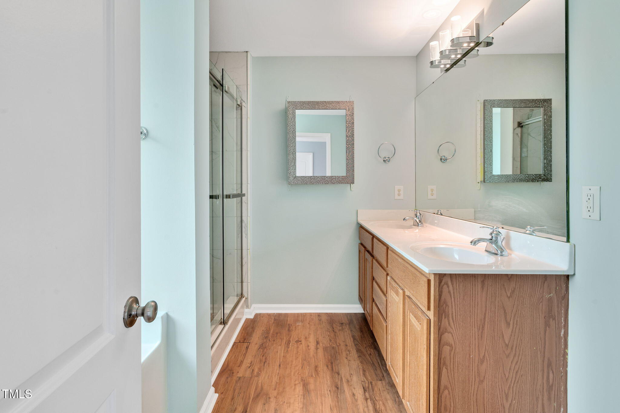 3805 Mike Levi Court Raleigh, NC 27610 - Photo 24 of 34 a bathroom with a double vanity sink a mirror and shower