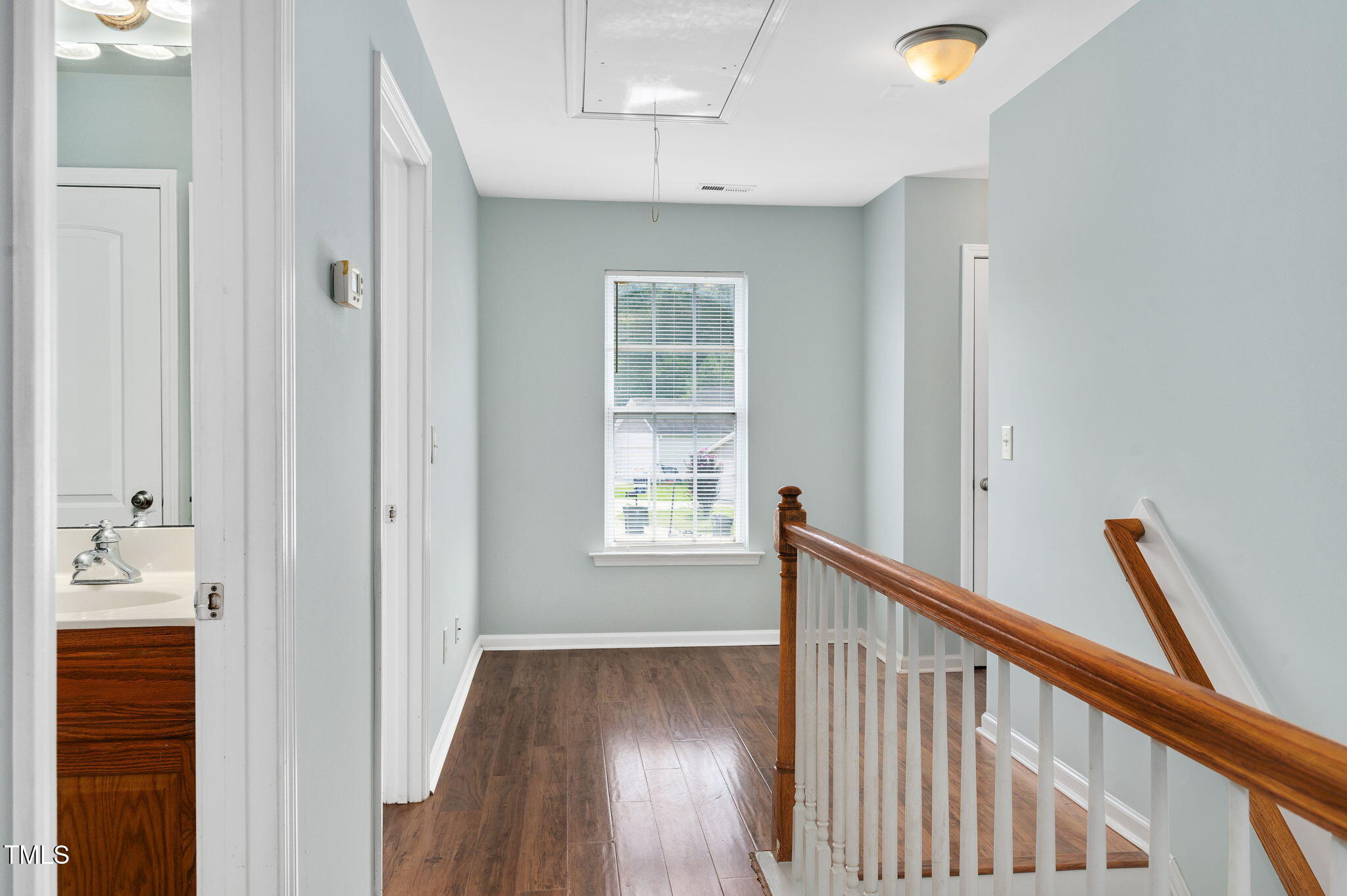 3805 Mike Levi Court Raleigh, NC 27610 - Photo 28 of 34 a view of hallway with wooden floor and staircase