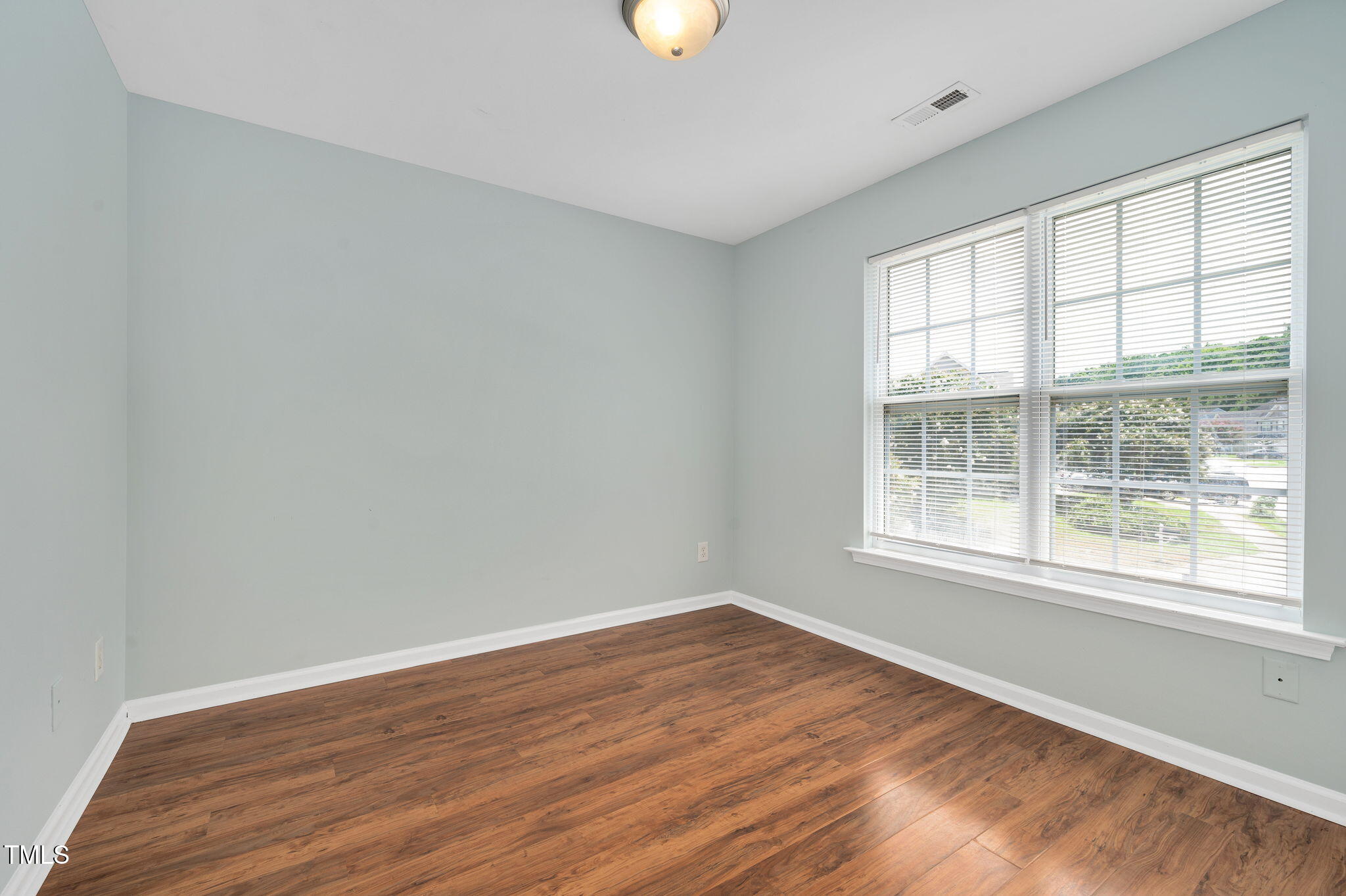 3805 Mike Levi Court Raleigh, NC 27610 - Photo 29 of 34 an empty room with wooden floor and windows