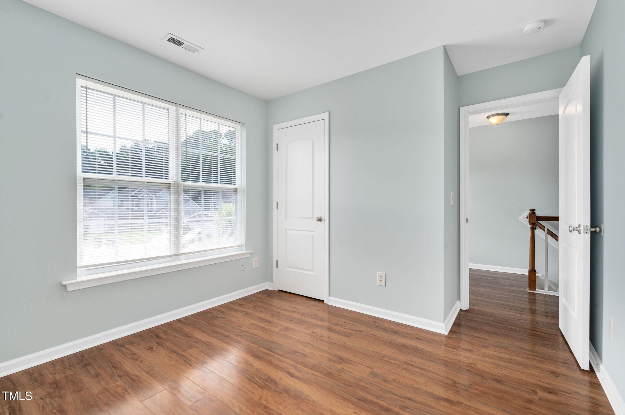 3805 Mike Levi Court Raleigh, NC 27610 - Photo 30 of 34 an empty room with wooden floor and a window