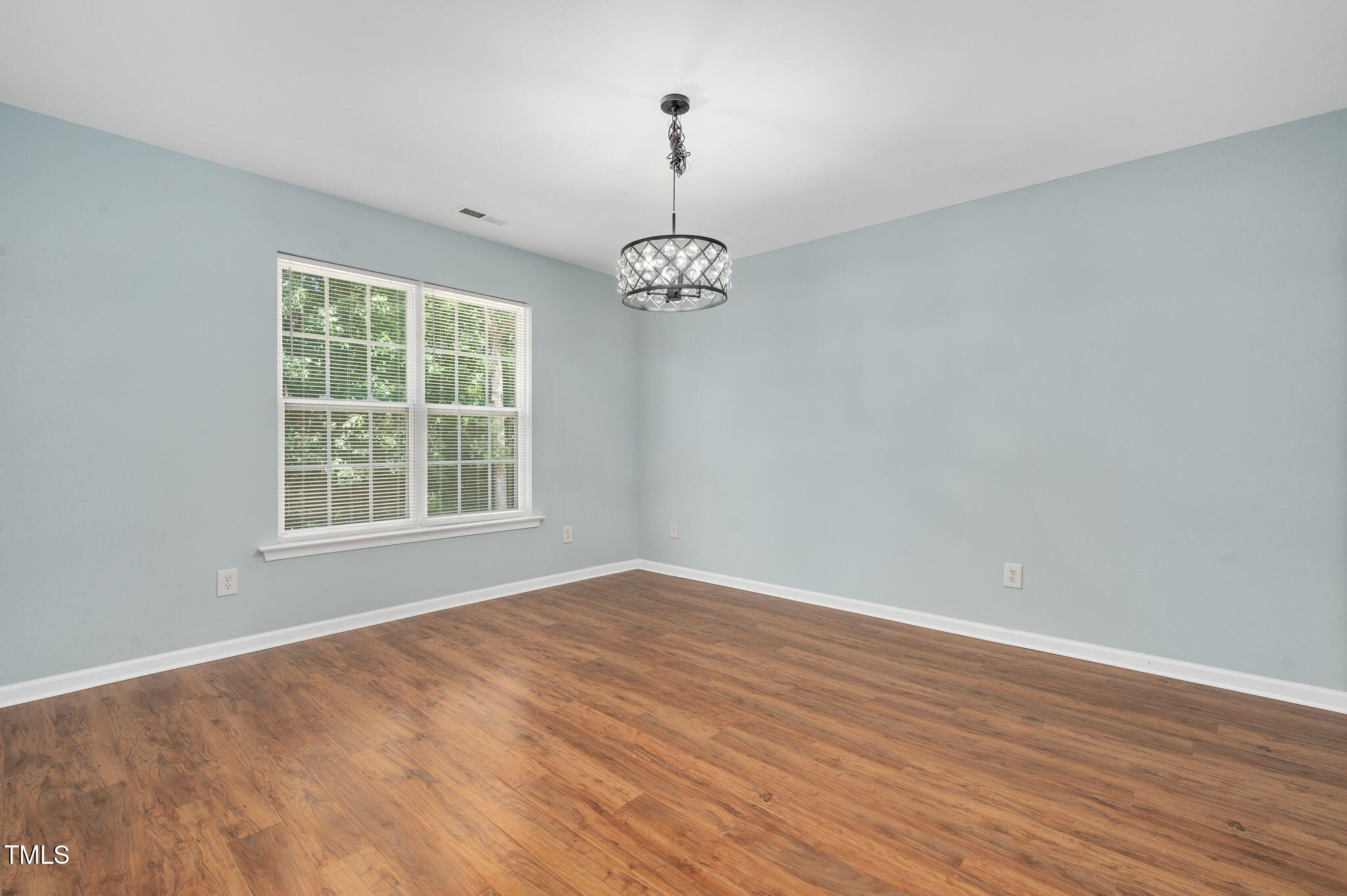 3805 Mike Levi Court Raleigh, NC 27610 - Photo 32 of 34 an empty room with wooden floor and windows