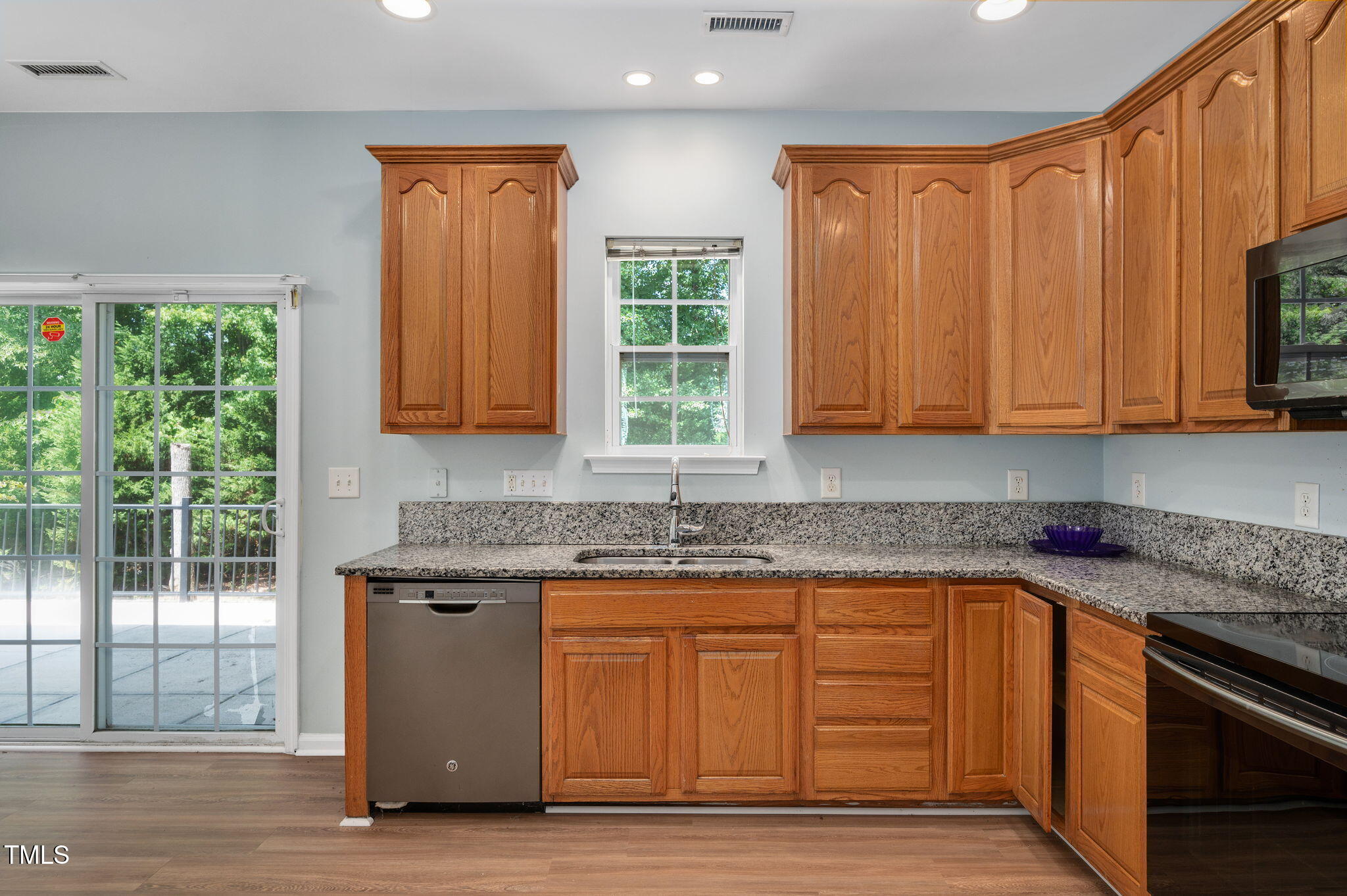3805 Mike Levi Court Raleigh, NC 27610 - Photo 6 of 34 a kitchen with granite countertop cabinets stainless steel appliances a sink and a window