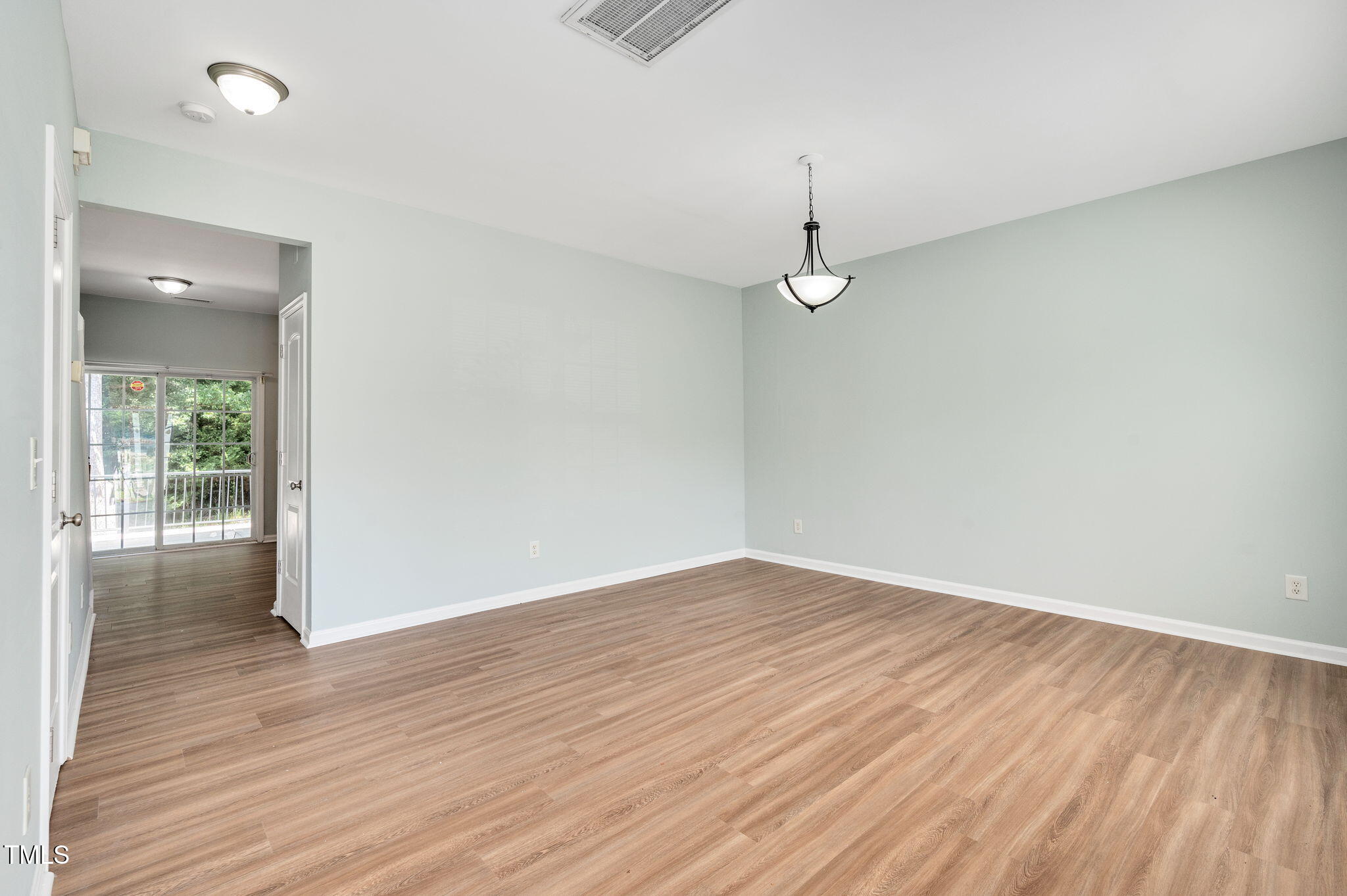 3805 Mike Levi Court Raleigh, NC 27610 - Photo 10 of 34 an empty room with wooden floor and windows