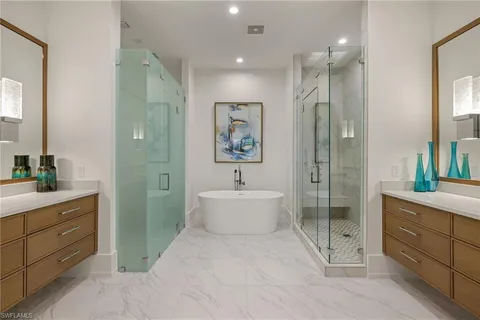 a bathroom with a double vanity sink toilet and shower