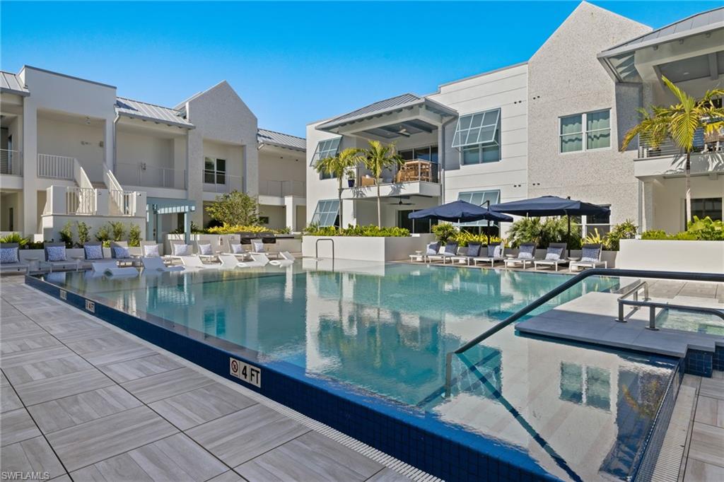 201 8th Street South, Unit 104 Naples, FL 34102 - Photo 33 of 40 a view of swimming pool with outdoor seating