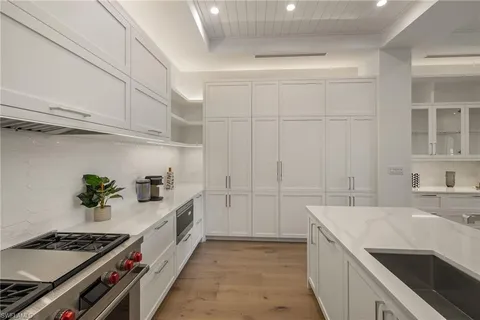 a kitchen with granite countertop a sink stove and cabinets
