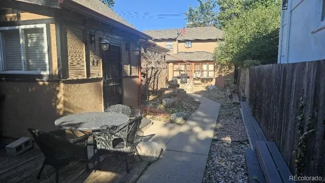 a backyard of a house with table and chairs