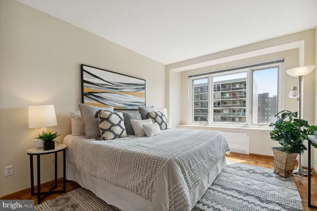 a bedroom with a bed and a potted plant