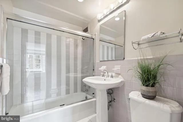 a bedroom with double bed and a potted plant