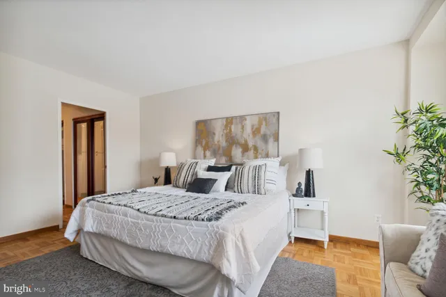 a bedroom with a bed and a table in it