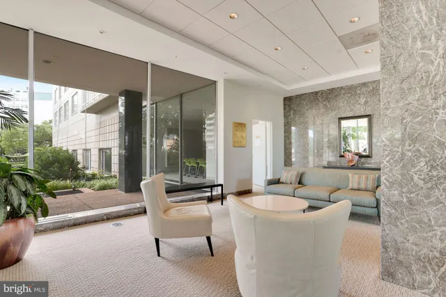 a living room with furniture and a large window