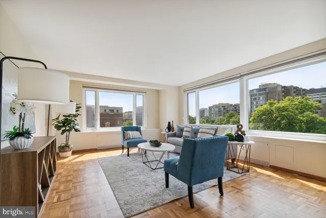 a living room with furniture and wooden floor