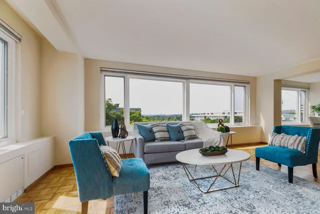 a dining room with furniture a chandelier and wooden floor