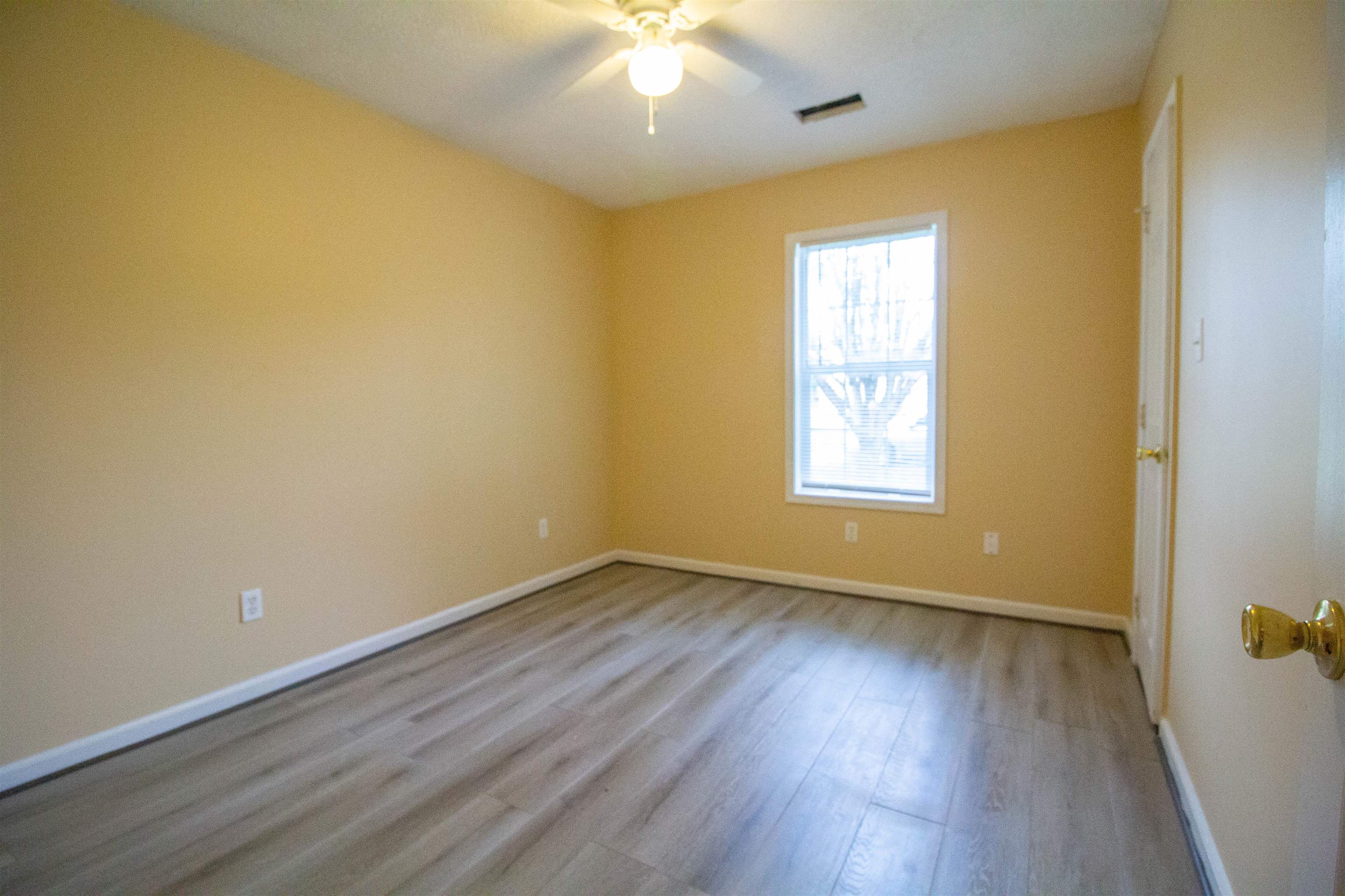 121 Kimberly Cove Ridgely, TN 38080 - Photo 10 of 22 a view of an empty room with wooden floor and a window