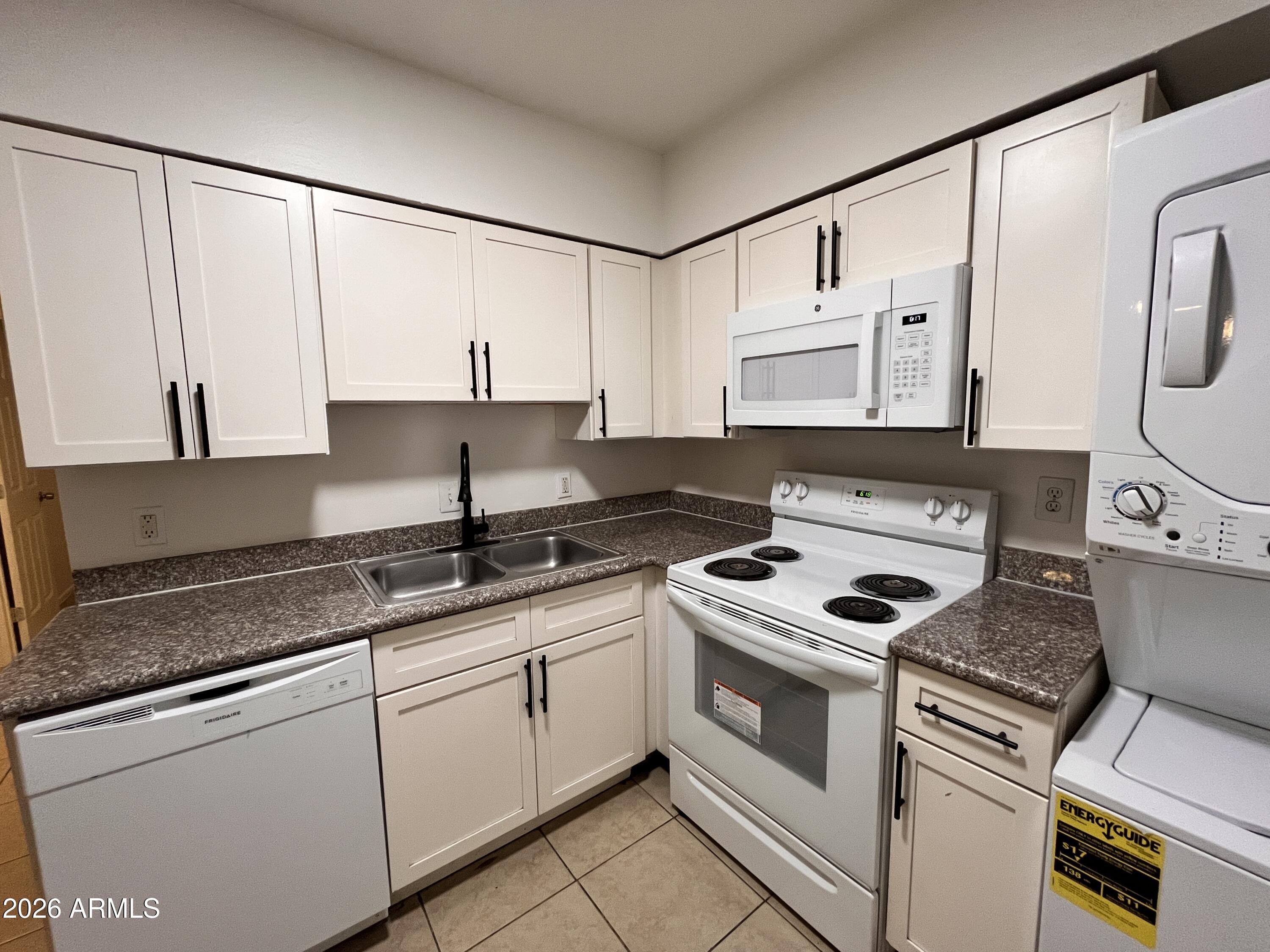 1224 South Smith Road Tempe, AZ 85281 - Photo 6 of 19 a kitchen with stainless steel appliances granite countertop a sink and a stove