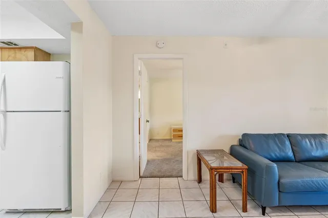 a bedroom with a bed a chandelier and a window
